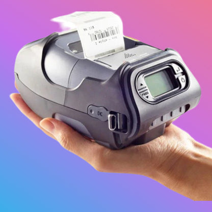 Hand holding a label printer with a colorful gradient background