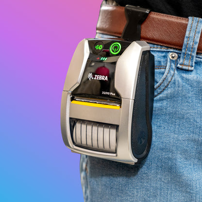 Zebra label printer attached to a person's waistband with a colorful gradient background